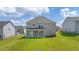 Spacious backyard featuring a covered patio, offering an ideal space for outdoor relaxation and entertainment at 2929 Champions Way, Loganville, GA 30052