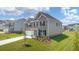 Attractive two-story home showcasing brick and siding, complemented by a well-manicured lawn and modern design at 2929 Champions Way, Loganville, GA 30052