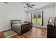 Cozy bedroom with natural light, hardwood floors, a ceiling fan, and a serene atmosphere at 639 Hall Station Rd, Kingston, GA 30145