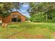 Charming barn-style home with a manicured lawn, surrounded by mature trees at 639 Hall Station Rd, Kingston, GA 30145