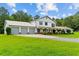 Traditional white home featuring a three-car garage and a large front yard at 639 Hall Station Rd, Kingston, GA 30145