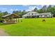 Picturesque view of a house with a gazebo in a sprawling green yard, creating an inviting outdoor space at 639 Hall Station Rd, Kingston, GA 30145