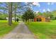 Scenic view of a well-maintained house with a long driveway, surrounded by lush greenery and blue skies at 639 Hall Station Rd, Kingston, GA 30145