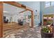 Grand foyer featuring wooden beams, modern lighting, and a glimpse into the bright, stylish kitchen at 639 Hall Station Rd, Kingston, GA 30145