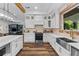 Bright kitchen featuring white cabinets, stainless steel appliances, a farmhouse sink, and quartz countertops at 639 Hall Station Rd, Kingston, GA 30145