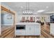 Kitchen island with white cabinets, quartz countertops, stainless steel microwave, and open floor plan at 639 Hall Station Rd, Kingston, GA 30145
