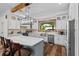 Well-lit kitchen featuring stainless appliances, a large island, and wood floors at 639 Hall Station Rd, Kingston, GA 30145