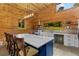 Beautiful kitchen featuring an island with countertop seating, modern appliances, and rustic wood paneling at 639 Hall Station Rd, Kingston, GA 30145