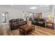 Comfortable living room with leather sofas, wooden floors, and an open view to the kitchen at 639 Hall Station Rd, Kingston, GA 30145