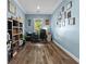 Bright home office with laminate wood floors and a wall of decorative photos at 639 Hall Station Rd, Kingston, GA 30145
