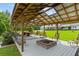 Covered outdoor lounge with fire pit, swing, and seating areas perfect for entertaining at 639 Hall Station Rd, Kingston, GA 30145