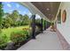 Covered porch with rocking chairs offers serene views of the lush front lawn at 639 Hall Station Rd, Kingston, GA 30145