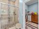 Modern shower boasts a glass door, stone bench, and sleek tile accents at 639 Hall Station Rd, Kingston, GA 30145