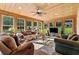 Bright sunroom filled with natural light, wood paneling, and comfortable seating for relaxation at 639 Hall Station Rd, Kingston, GA 30145