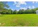 Expansive green yard with mature trees offers tranquility and endless possibilities at 639 Hall Station Rd, Kingston, GA 30145