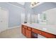 Primary bathroom features a soaking tub, stall shower, and a double sink vanity with white countertop at 9996 Village South Dr, Douglasville, GA 30135
