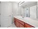 Bright bathroom featuring a large mirror over the vanity and a glimpse into an adjacent room at 9996 Village South Dr, Douglasville, GA 30135