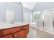 Primary bathroom featuring double sinks, soaking tub, glass shower, and private commode at 9996 Village South Dr, Douglasville, GA 30135