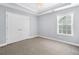 Bedroom featuring neutral paint, carpeting, window and large closet at 9996 Village South Dr, Douglasville, GA 30135