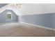 Bonus room on the third floor with carpet, natural light and neutral walls at 9996 Village South Dr, Douglasville, GA 30135