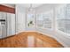 Bright eat-in kitchen area with hardwood floors, stainless steel refrigerator, and natural lighting at 9996 Village South Dr, Douglasville, GA 30135