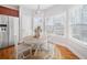 Eat-in kitchen area featuring hardwood floors, stainless steel refrigerator, and natural lighting at 9996 Village South Dr, Douglasville, GA 30135