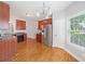 Bright kitchen features stainless steel appliances, granite countertops and a hardwood floor at 9996 Village South Dr, Douglasville, GA 30135