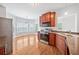 Updated eat-in kitchen features stainless steel appliances and wood cabinets and hardwood floor at 9996 Village South Dr, Douglasville, GA 30135
