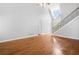 Open living room with hardwood floors, high ceilings, staircase, and lots of natural light at 9996 Village South Dr, Douglasville, GA 30135