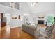 Spacious living room with hardwood floors, fireplace, and view into dining room and kitchen at 9996 Village South Dr, Douglasville, GA 30135