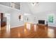 Bright living room with hardwood floors, fireplace and view into dining room and kitchen at 9996 Village South Dr, Douglasville, GA 30135