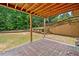 Covered patio area with brick pavers, offering a shaded outdoor space for leisure at 9996 Village South Dr, Douglasville, GA 30135