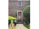 Charming brick home featuring a decorative front door with storm door and a well maintained front garden at 105 Glen Acres Ct, Decatur, GA 30035