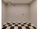 Unfinished basement laundry room with checkerboard floors at 216 Hickory Way, Canton, GA 30115
