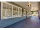 Inviting covered porch with wood floors offering a relaxing outdoor space, and charming details at 216 Hickory Way, Canton, GA 30115