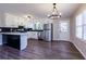 Bright kitchen with white cabinets, stainless steel appliances, modern flooring, and a black backsplash at 216 Hickory Way, Canton, GA 30115