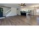 Spacious living area with stairs, an open-concept kitchen, stainless steel appliances, and modern flooring at 216 Hickory Way, Canton, GA 30115