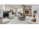 Staged living room showcasing a stone fireplace, modern furniture, and an open kitchen design at 216 Hickory Way, Canton, GA 30115