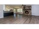 Open-concept living space featuring a stone fireplace and updated kitchen with stainless steel appliances at 216 Hickory Way, Canton, GA 30115