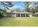 Large backyard with a covered patio and a brick house at 2292 Country Club Sw Ln, Atlanta, GA 30311