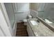 Well-lit bathroom with a granite countertop, a mirror and a white tiled shower and tub combination at 2292 Country Club Sw Ln, Atlanta, GA 30311