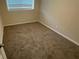 Comfortable bedroom featuring carpeted flooring, neutral walls, and a large window, creating a cozy atmosphere at 2292 Country Club Sw Ln, Atlanta, GA 30311