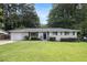 Charming single-story brick home with a well-manicured front lawn and mature trees in a quiet neighborhood at 2292 Country Club Sw Ln, Atlanta, GA 30311
