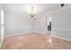 Bright dining room features tile floors, a modern chandelier and classic chair rail molding at 3123 Westbrook Trce, Lawrenceville, GA 30044