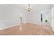 Bright dining room features tile floors, a modern chandelier and an open floor plan at 3123 Westbrook Trce, Lawrenceville, GA 30044