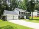 Charming two-story home with a two-car garage and well-manicured lawn and mature trees at 3123 Westbrook Trce, Lawrenceville, GA 30044