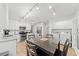 Open concept kitchen with stainless appliances, a center island, and adjacent laundry room at 3123 Westbrook Trce, Lawrenceville, GA 30044