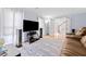 Inviting living room with hardwood floors, a modern entertainment center, and comfortable seating at 3123 Westbrook Trce, Lawrenceville, GA 30044