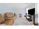 Comfortable living room with hardwood floors, a modern entertainment center, and plush leather seating at 3123 Westbrook Trce, Lawrenceville, GA 30044
