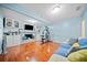 Entertainment space features a fireplace, wood floors, and blue accents at 3123 Westbrook Trce, Lawrenceville, GA 30044